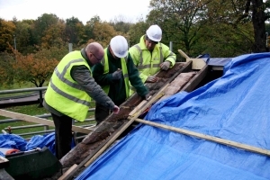 Workmen lay the new vestry roof