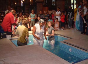 Tanice Weir leaves the pool after her baptism