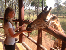 Beth Jolley feeding a giraffe