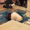 Rajwinder Kaur is baptised by Revd Fiona Robertson, assisted by Ken Costley