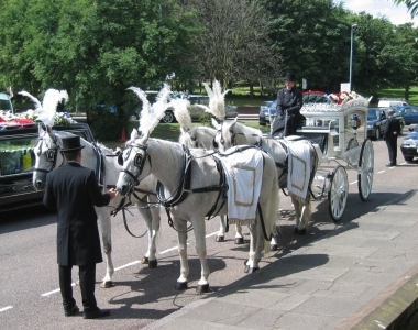 Horse drawn hearse outside aston parish church